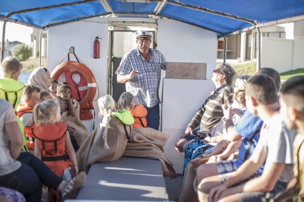 Captain talking to tourists on boat trip, Cape Town, South Africa Captain talking to tourists on boat trip, Cape Town, South Africa